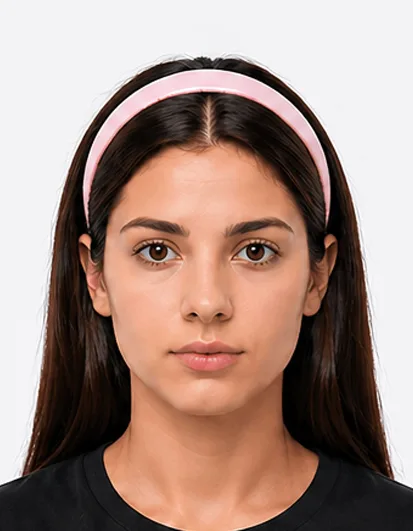 Passport photo example showing person wearing a hairband, which is not permitted in UK passport photos